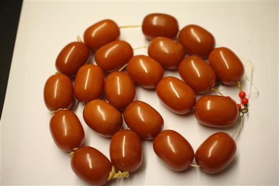 A single strand amber bead necklace and similar bracelet, necklace 22in.